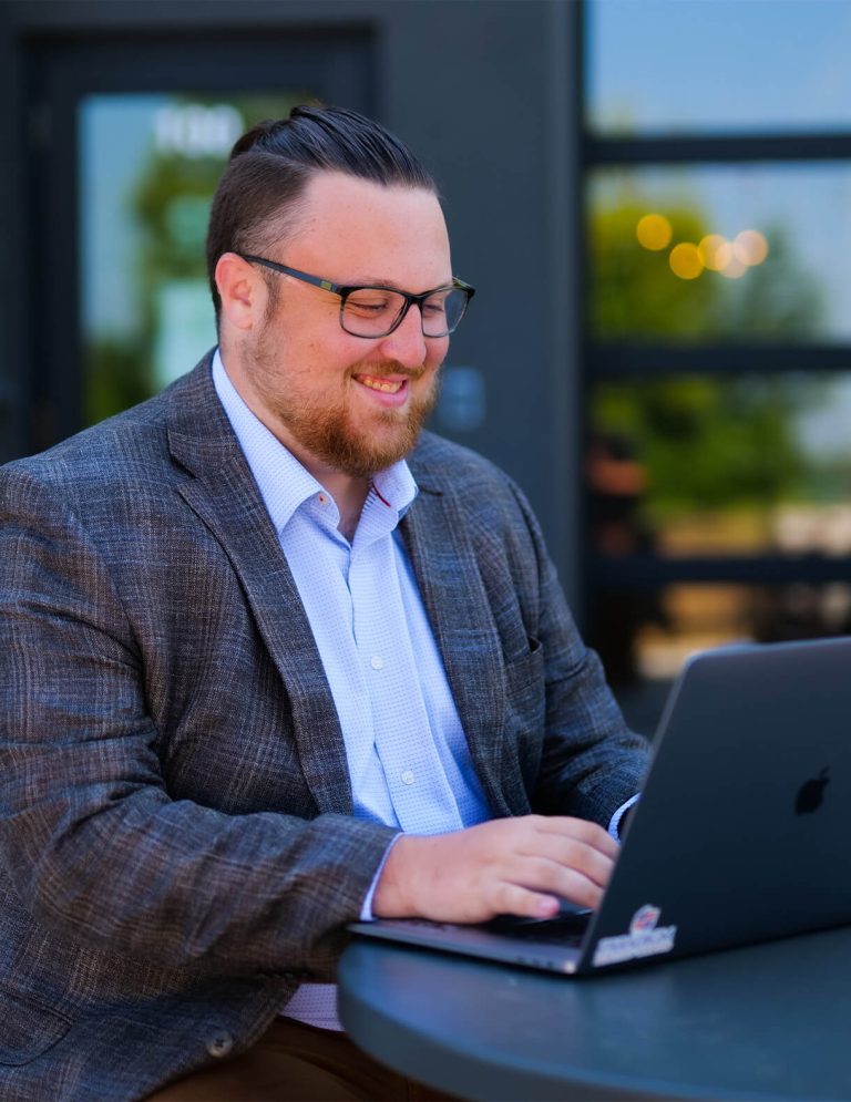 Image of Digital Strategist, Lawson Hearne, working on a laptop at Paradigm Digital Group offices